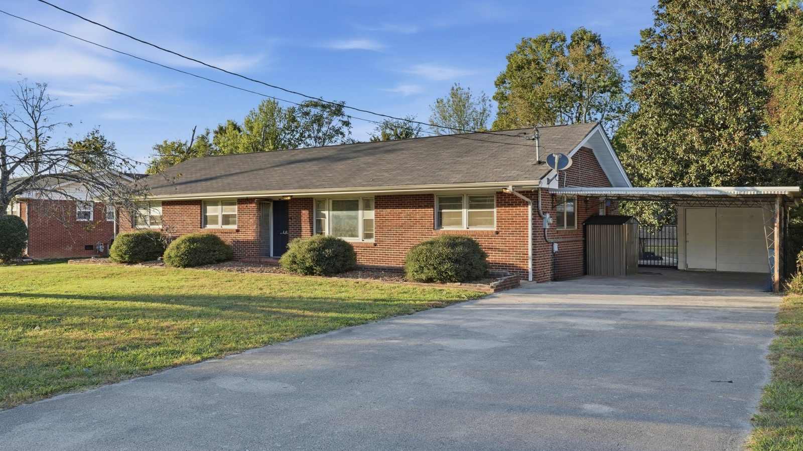 Front of the brick ranch home with driveway and carport at 1003 Oak Drive
