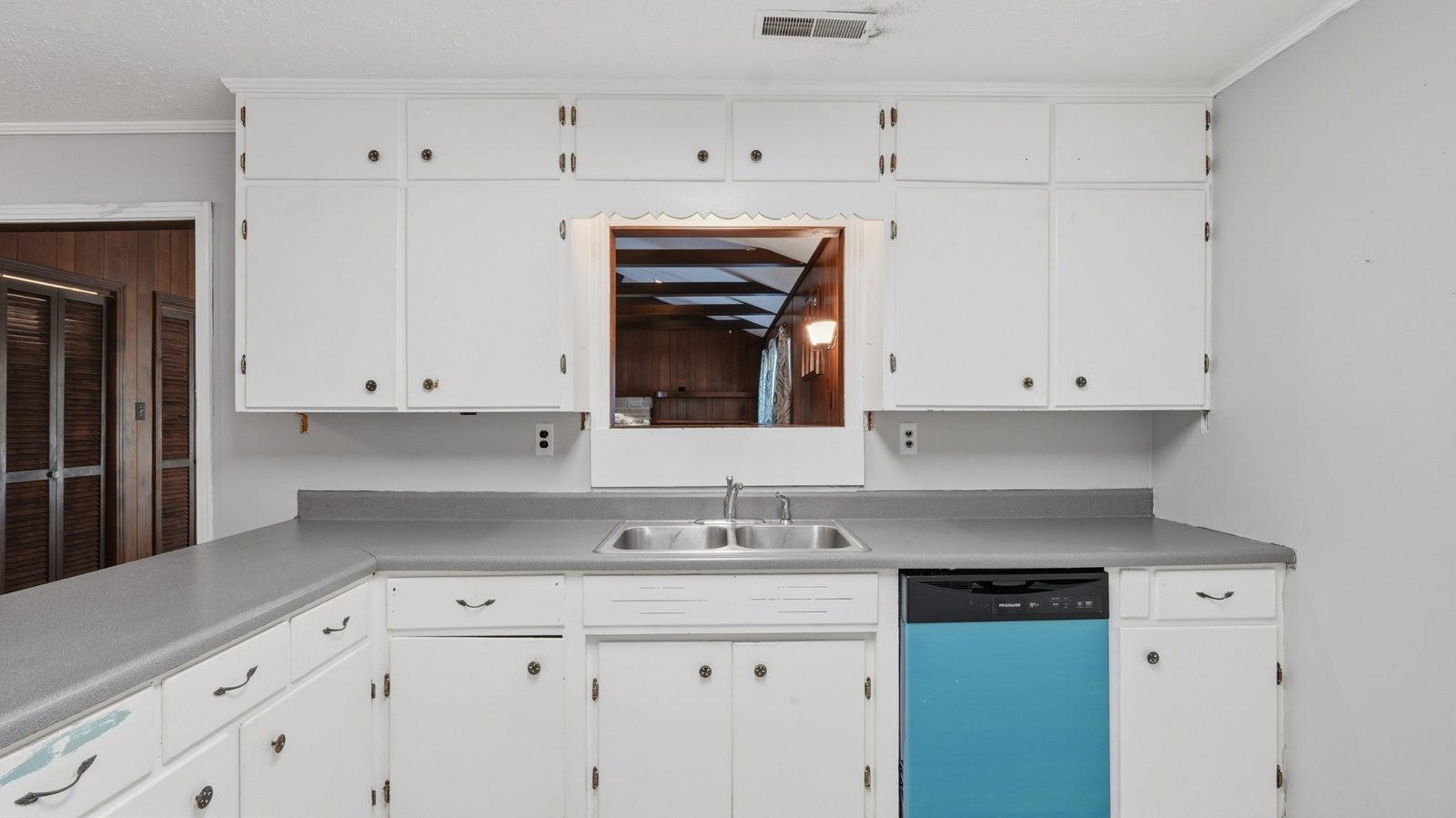 Kitchen sink area and cabinetry at 1003 Oak Drive