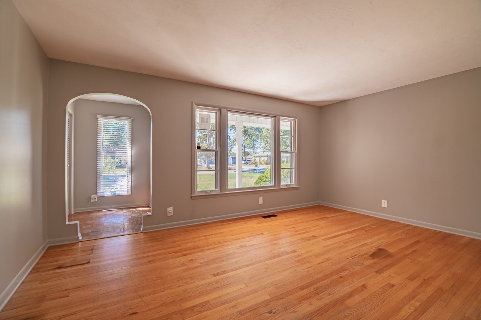 Room with hardwood floors and arched doorway at 1201 Woodcrest Drive