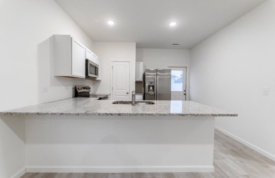 Kitchen breakfast bar, shown for the same floor plan at 18 Stonehenge Circle NW