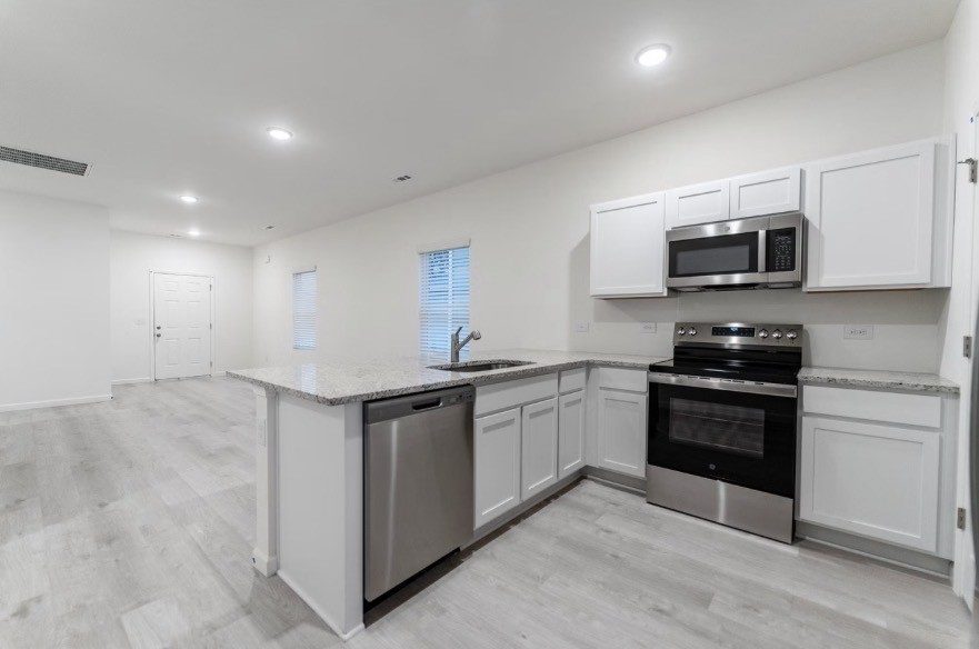 Kitchen with stainless appliances, shown for the same floor plan at 19 Stonehenge Circle NW