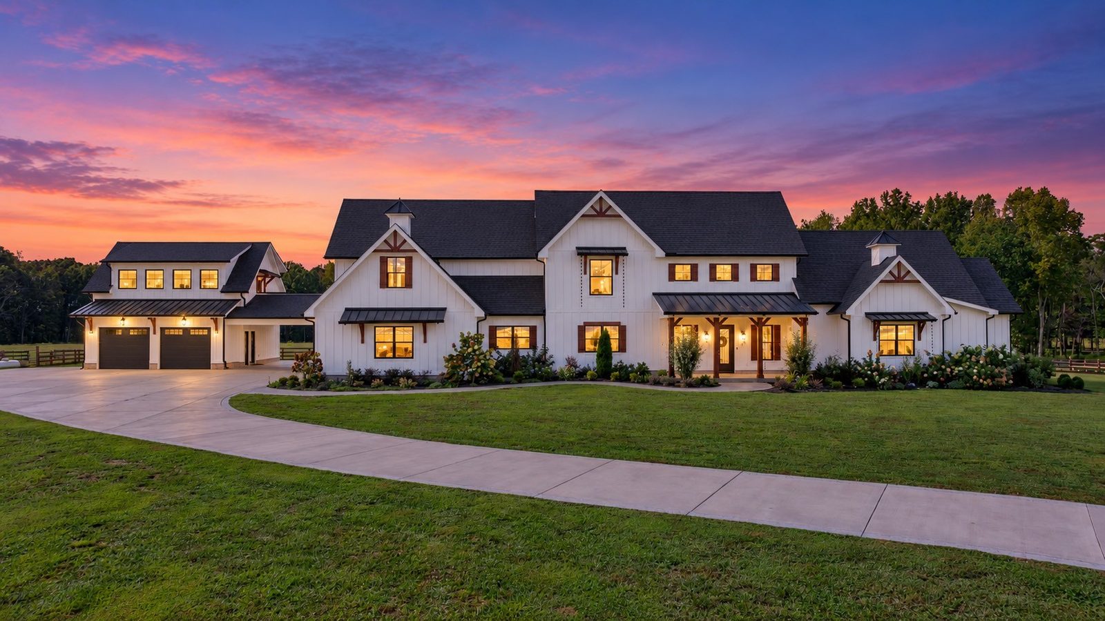 Front of the white estate home at dusk with a circular drive at 2216 Sp Anderson Road