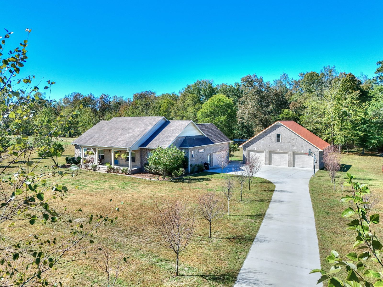 Front of the home with a detached three bay garage and long driveway at 247 Days End Lane