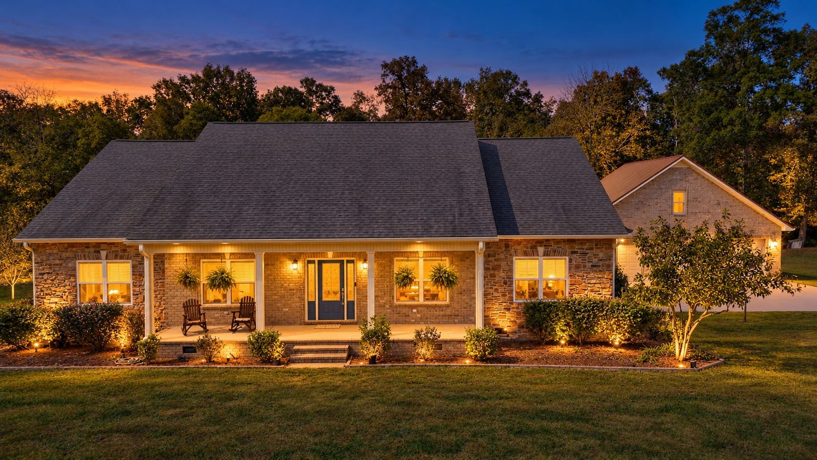 Front of the home at dusk with porch lights on at 247 Days End Lane