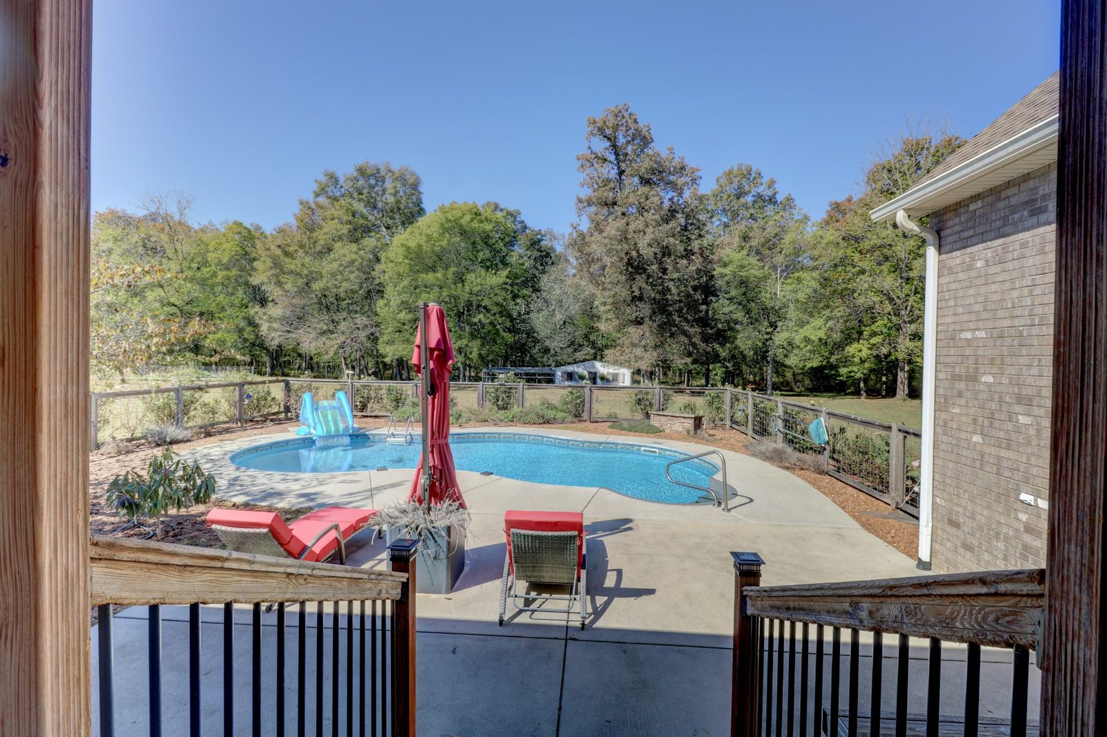 In ground pool viewed from the back deck at 247 Days End Lane
