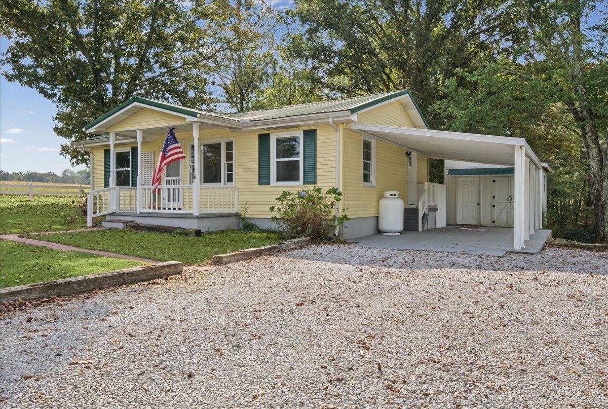 Gravel drive, porch and carport at 3057 Mt View Road