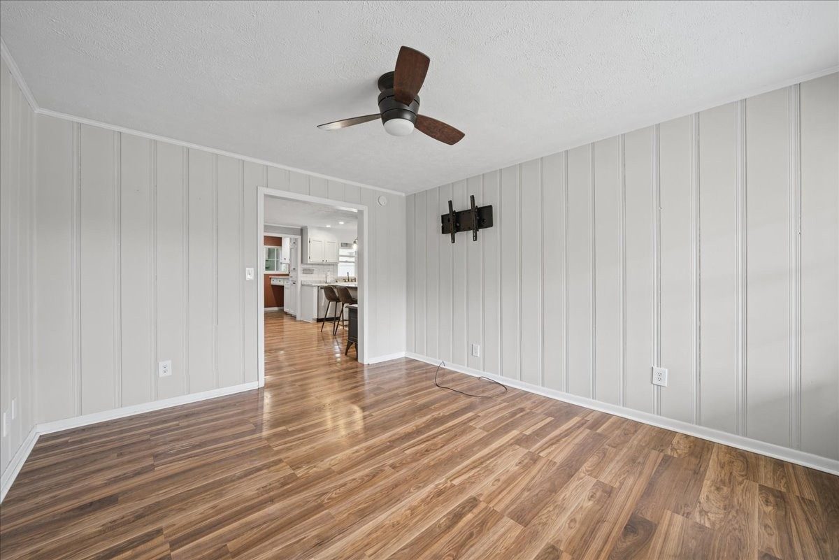 Living room with paneled walls and wood look floors at 3057 Mt View Road