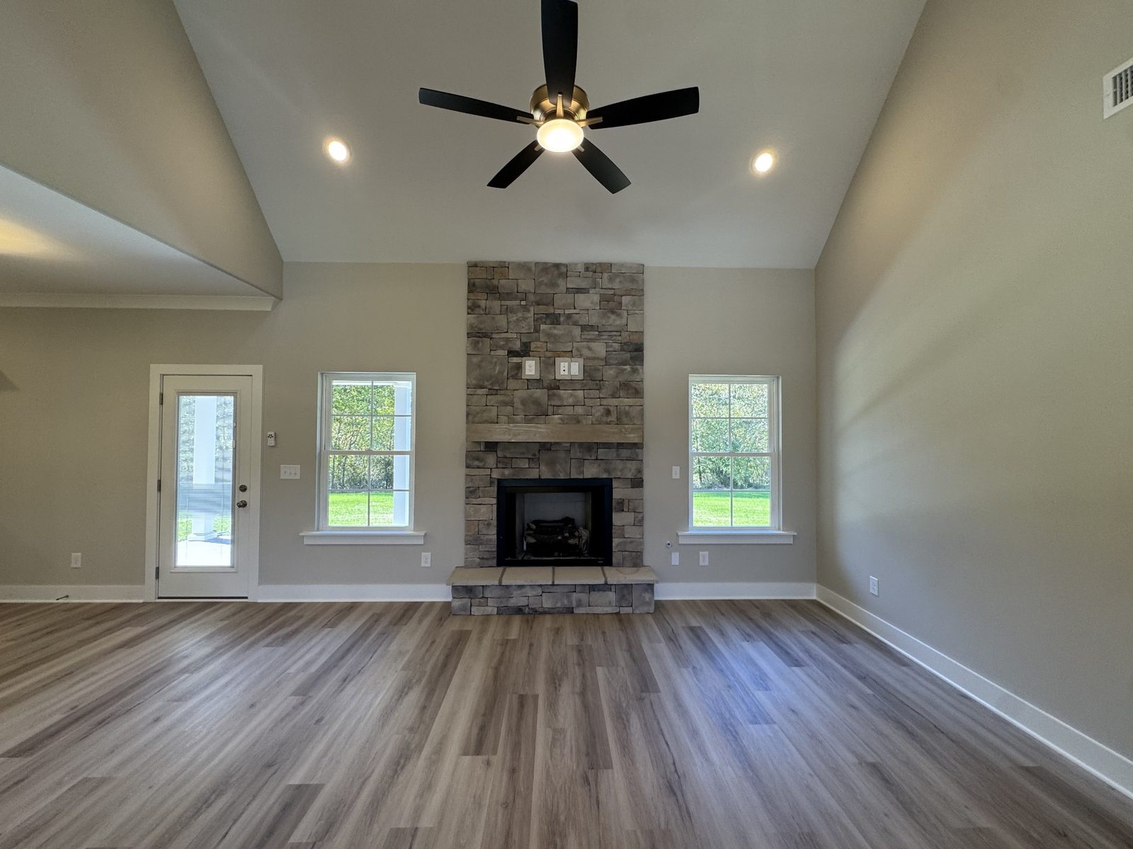 Living room with stone fireplace at 61 Spring House Drive