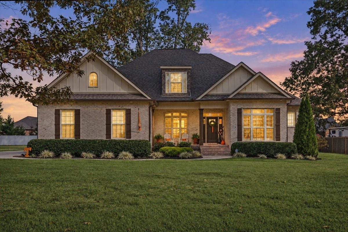 Front of the home at dusk with lights on at 612 Lexington Circle