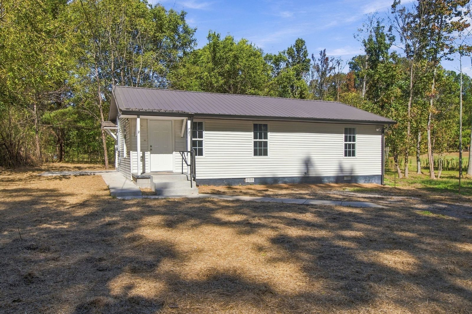 Side angle of the home exterior and yard at 721 Taylor Road