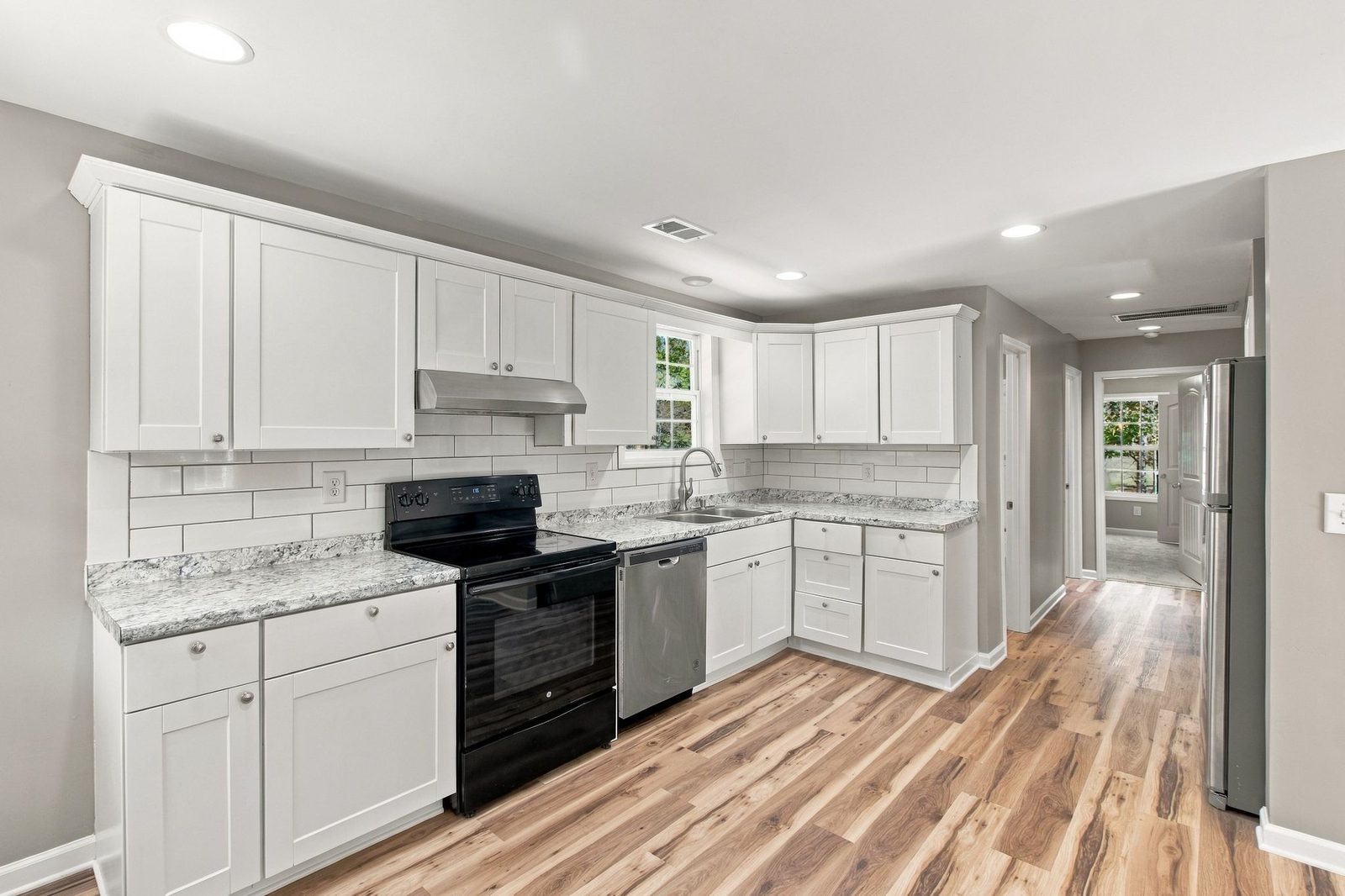 Renovated kitchen with white cabinets and black appliances at 721 Taylor Road