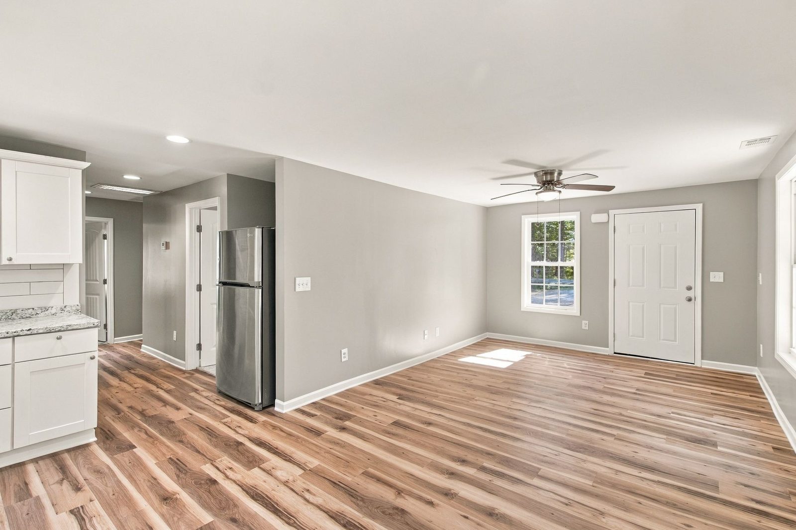 Kitchen and living area with new flooring at 721 Taylor Road