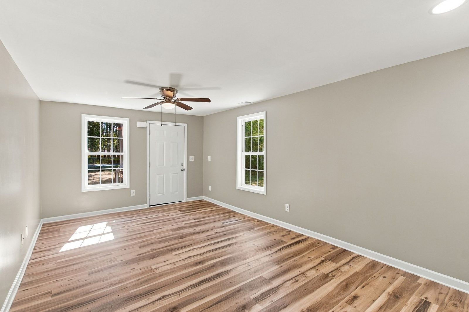 Living room with ceiling fan and natural light at 721 Taylor Road
