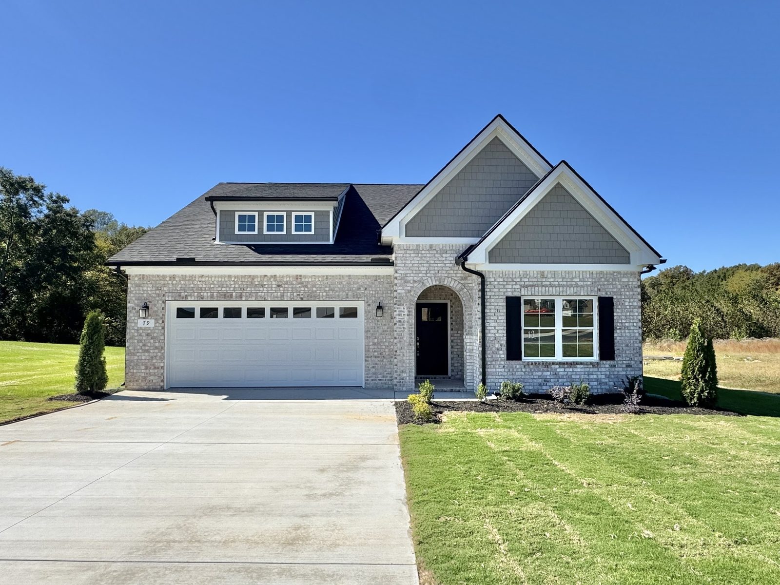 Front of the new single story home with a two car garage at 79 Spring House Drive