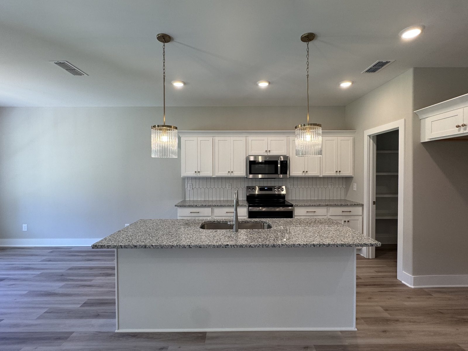 Kitchen with island and pendant lights at 79 Spring House Drive