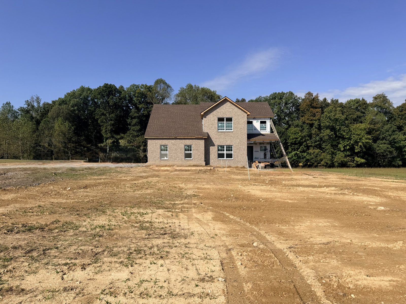 Home set back on a cleared lot with woods behind at 8689 Fredonia Road