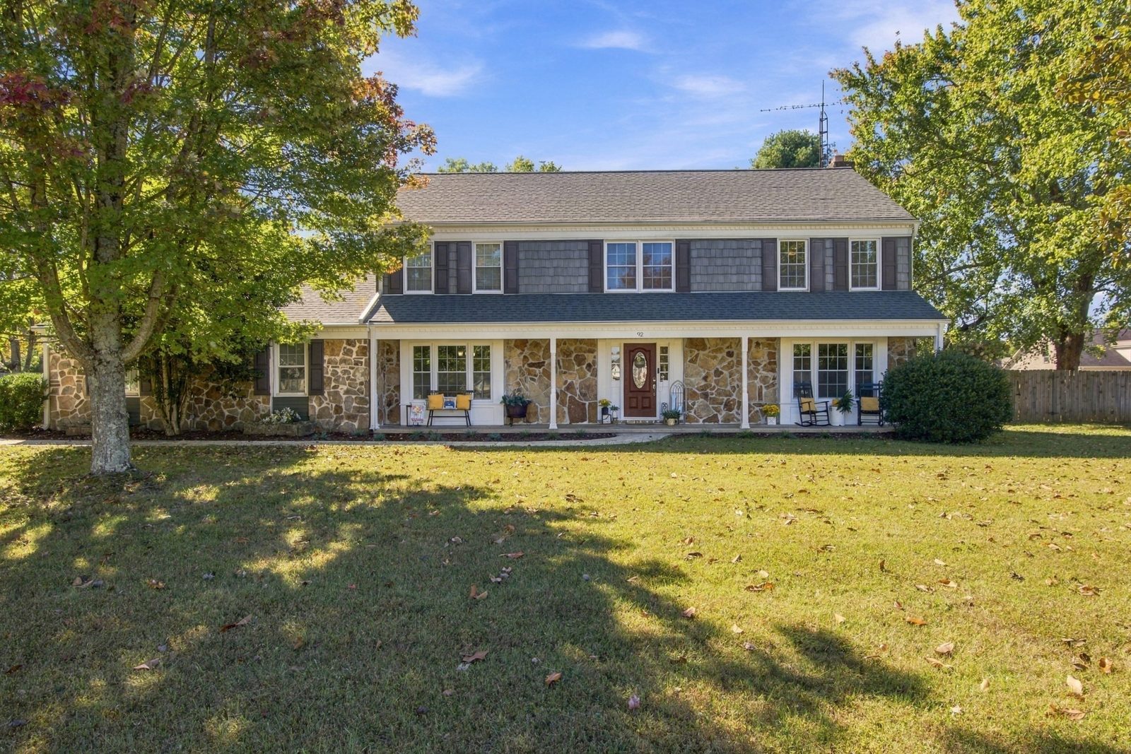 Front of the two story home with a long covered porch at 92 Bluegrass Road